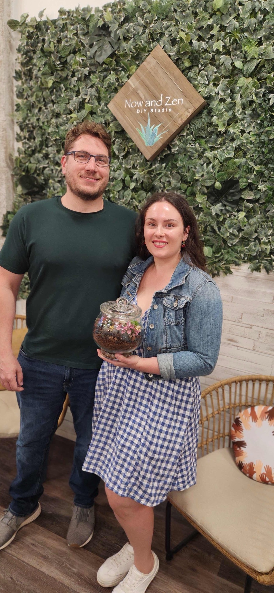 A couple laughing while building terrariums together