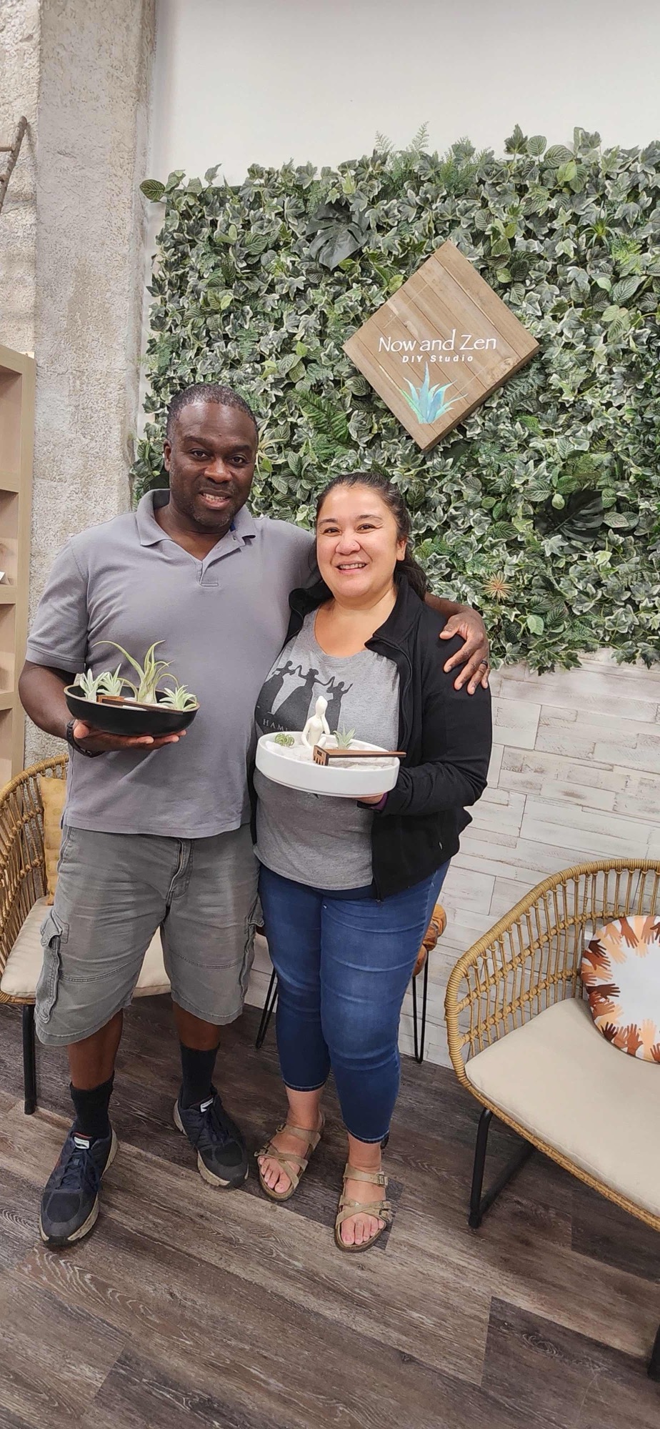 Two people celebrating with their finished terrariums