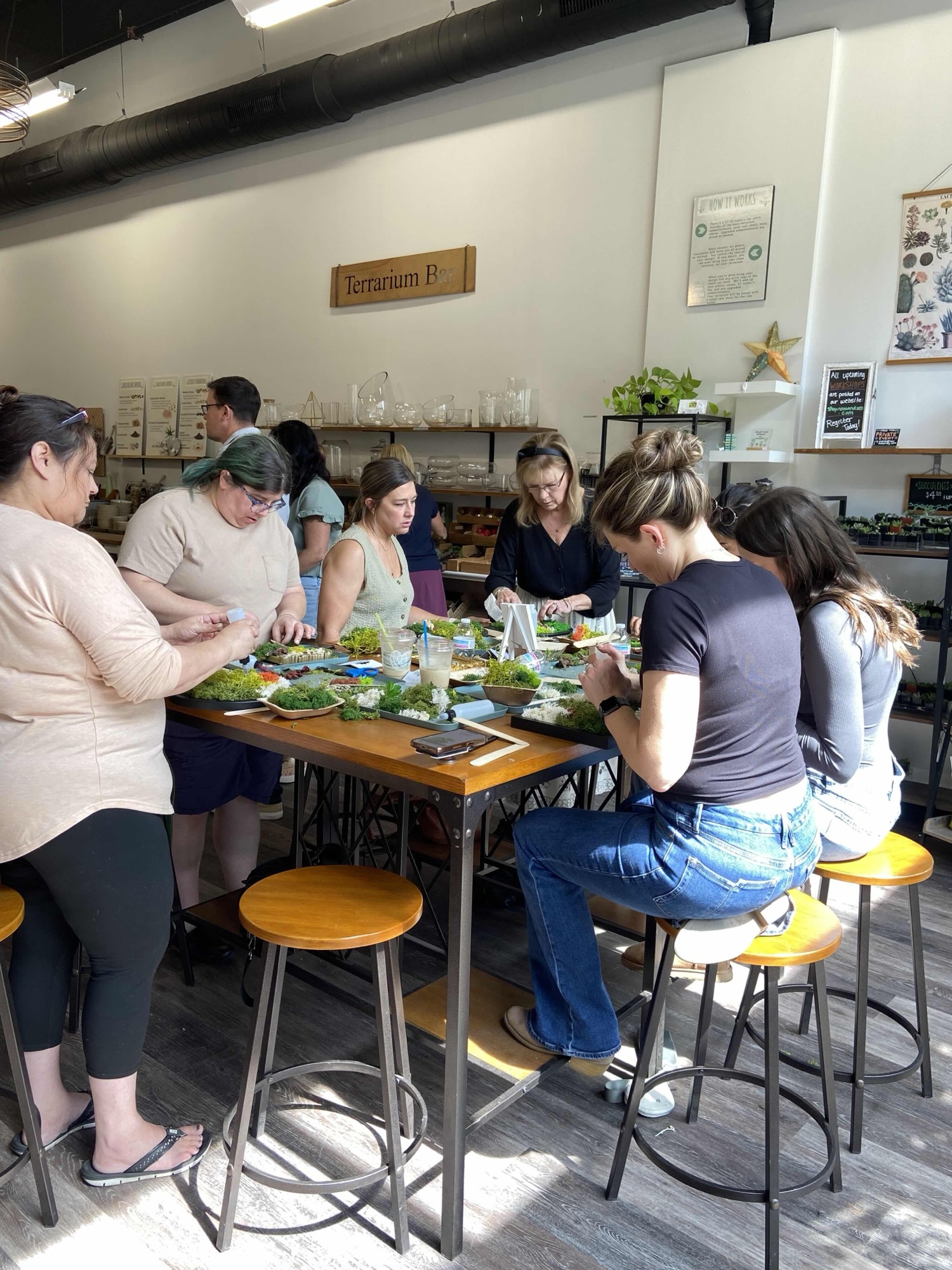 A group building terrariums together at an offsite event