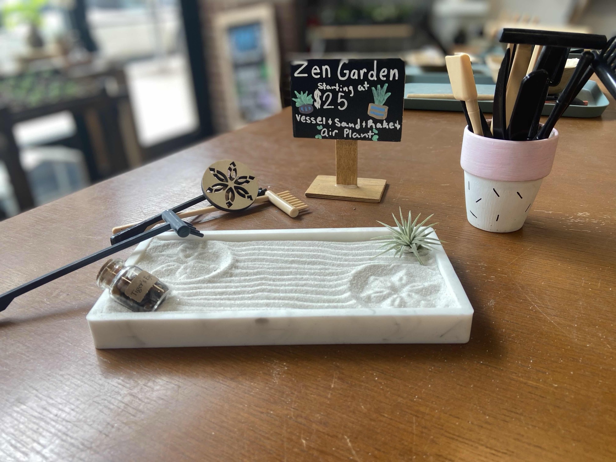 A zen garden with layered sand and greenery